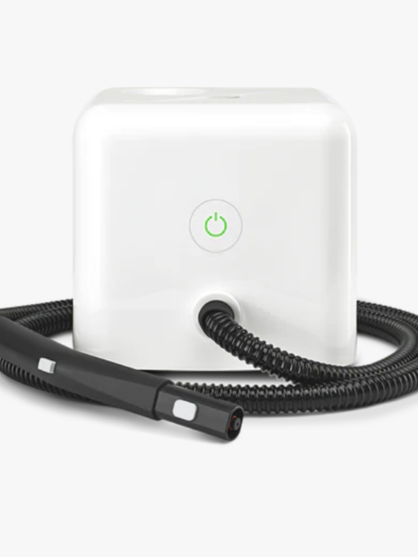 A compact, white steamer with a coiled black hose attached. The device has a square shape and a power button symbol on its front. The hose appears to be extendable and portable.
